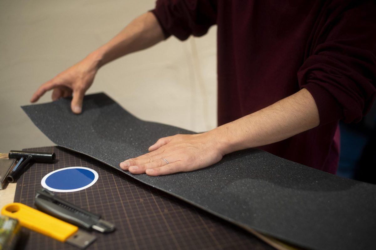 close up hands working with grip tape.jpg